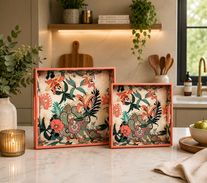 Handcrafted wooden serving trays with coral-pink edges and a vintage floral pattern in orange, green, pink, and cream.
